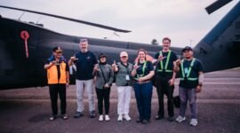 Kepala BPBD Provinsi Lampung Aswarodi (paling kiri, rompi oranye) berfoto bersama tim Satgas Udara dan kru di depan helikopter water bombing BNPB yang disiagakan untuk penanggulangan karhutla.